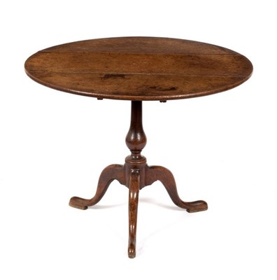 Lot 623 - An oak table on turned column and tripod...