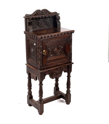 Lot 631 - A small carved oak cupboard on spiral legs,...