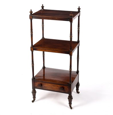 Lot 662 - A Regency rosewood three tier whatnot on...