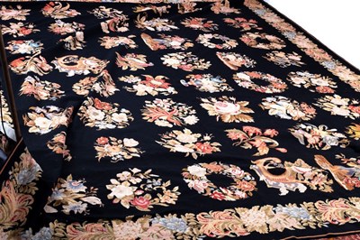 Lot 770 - A needlework carpet decorated floral sprays to...