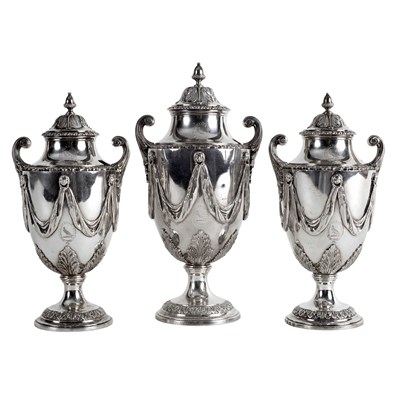 Lot 266 - A garniture of three George III silver sugar...