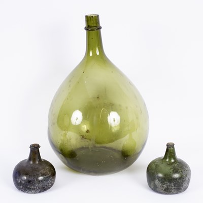 Lot 423 - A large green glass flagon, 54cm high and two...