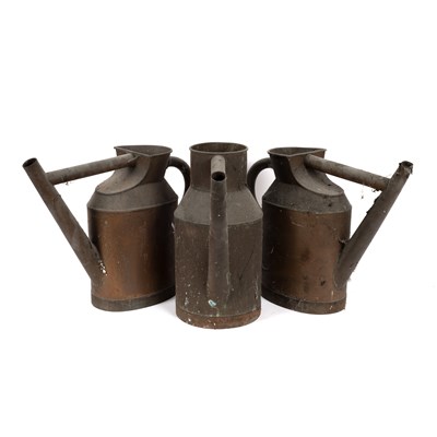 Lot 580 - Three copper watering cans, 42cm high