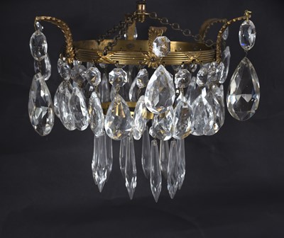 Lot 600 - A pendant ceiling lustre, the two circular...