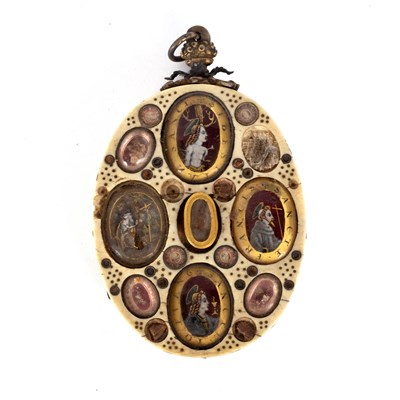 Lot 606 - An oval reliquary ivory pendant, Italian or...