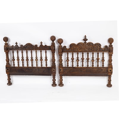 Lot 650 - An Iberian carved walnut bedhead and footboard,...