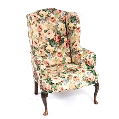 Lot 695 - A Queen Anne walnut wing armchair, circa 1710,...