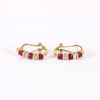 Lot 740 - A pair of ruby and diamond half hoop earrings,...