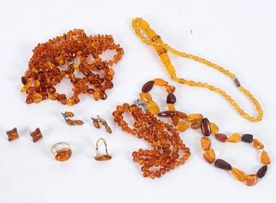 Lot 15 - A quantity of amber bead necklaces, two amber...
