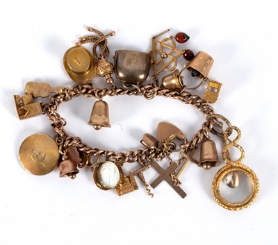 Lot 17 - A 9ct rose gold charm bracelet with curb link...