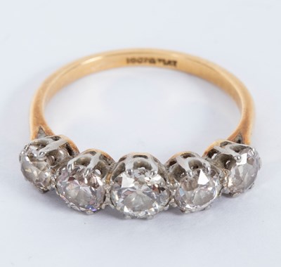 Lot 29 - A diamond five-stone ring in a scroll setting,...