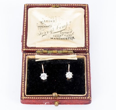 Lot 39 - A pair of diamond earrings, each with single...