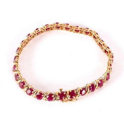 Lot 53 - A ruby and diamond bracelet, set in 14k yellow...
