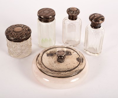 Lot 109 - A quantity of silver-topped scent bottles and...