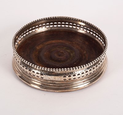 Lot 125 - A George III silver wine coaster, London 1802,...