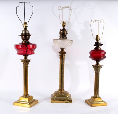 Lot 473 - Three oil lamps, converted for electricity,...