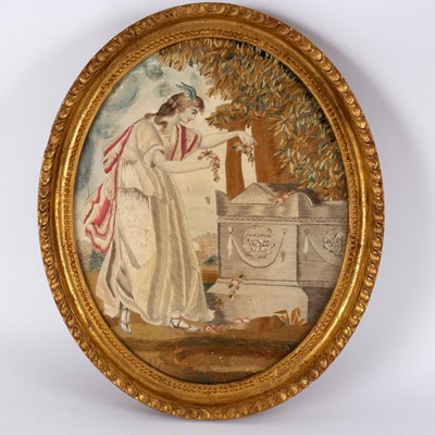 Lot 516 - A Georgian oval needlework sampler of a woman...