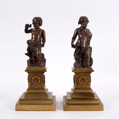 Lot 559 - A pair of bronze figures of putti, one with an...