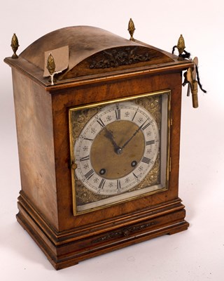 Lot 576 - A German walnut cased mantel clock, the square...