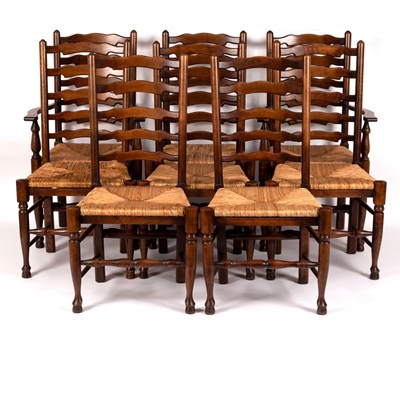 Lot 717 - Eight elm ladder back chairs with rush seats...