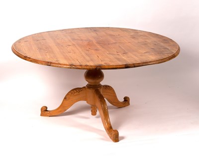 Lot 763 - A circular pitch pine table on a turned column...