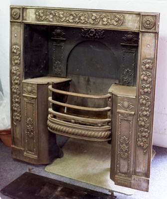 Lot 787 - A burnished steel fire grate, the surround...