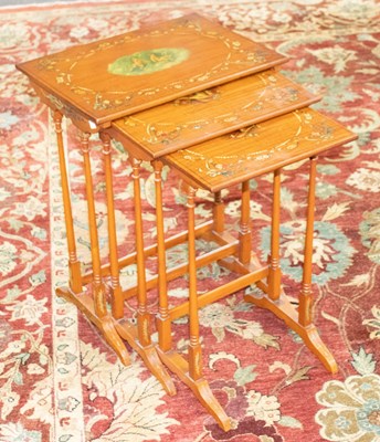 Lot 858 - A nest of three satinwood tables, with painted...