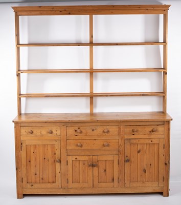 Lot 868 - A pine dresser, the open rack above a base...