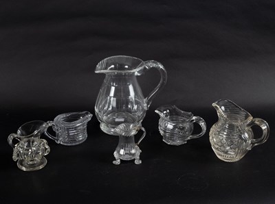 Lot 100 - A small 18th Century glass cream jug set on...