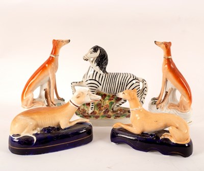 Lot 165 - A Staffordshire pottery zebra, 21cm high, a...