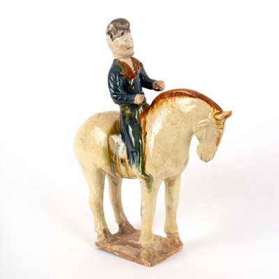 Lot 219 - A Tang dynasty equestrian figure, sancai and...