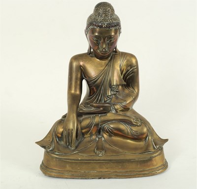 Lot 235 - An Eastern bronze figure of a seated buddha,...