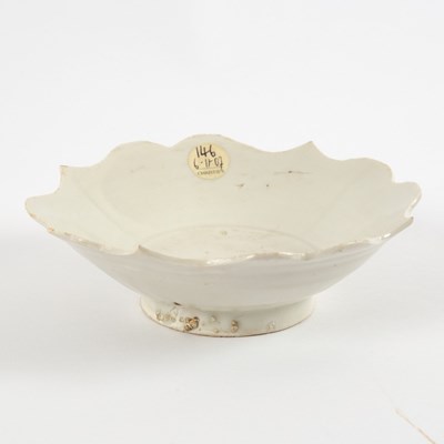 Lot 258 - A white glazed foliate dish, Song dynasty, the...