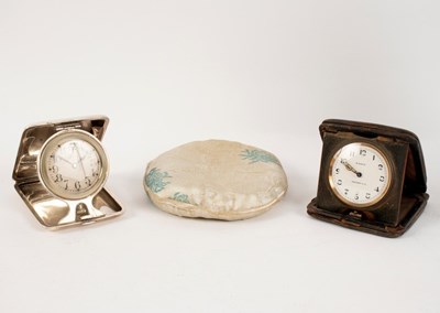 Lot 1050 - A silver cased bedside clock by Elgin, the...