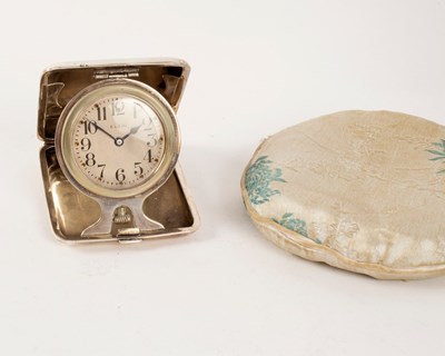Lot 1050 - A silver cased bedside clock by Elgin, the...