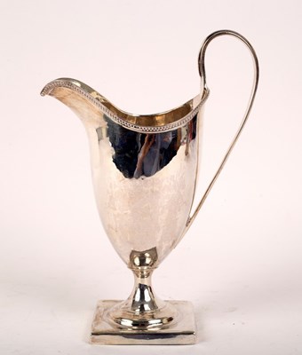 Lot 25 - A George III silver helmet-shaped cream jug,...