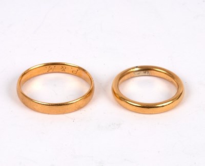 Lot 167 - Two 22ct gold wedding bands, sizes U and M½,...