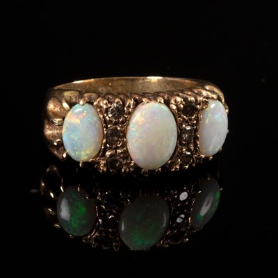 Lot 173 - An opal and diamond ring, the three oval opals...