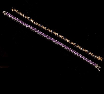 Lot 213 - A diamond and sapphire bracelet, set in 9ct...