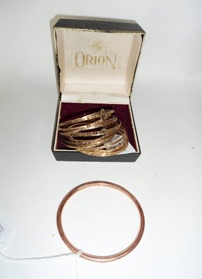 Lot 216 - A 9ct rose gold bangle of plain circular form...