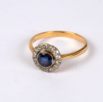 Lot 228 - A sapphire and diamond cluster ring, the...