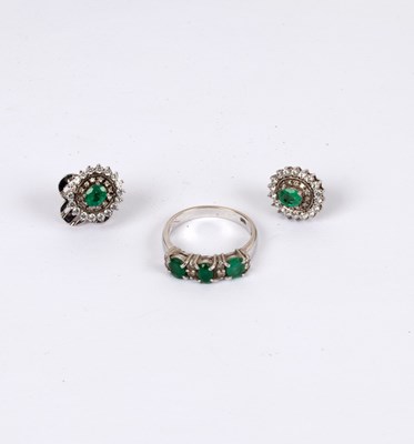 Lot 231 - An emerald and diamond ring, the three oval...