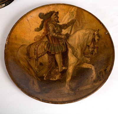 Lot 332 - A papier-mâché charger decorated a knight on...