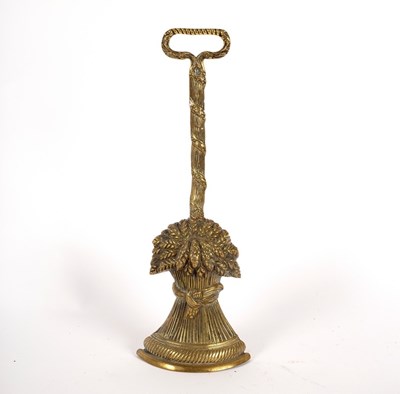 Lot 339 - A brass door porter in the form of a wheat...