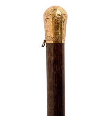 Lot 341 - A malacca walking cane with gold engraved top...