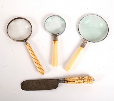 Lot 344 - A magnifying glass with spirally reeded handle,...