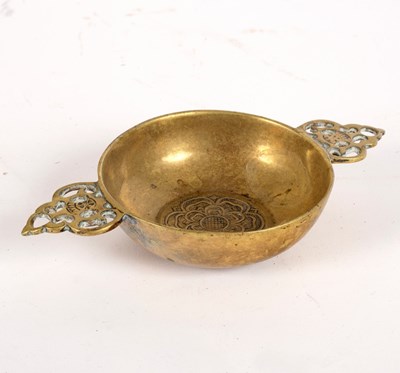 Lot 349 - A small brass porringer with pierced foliate...