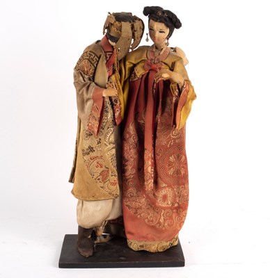 Lot 524 - Two Japanese composition dolls in brocade...