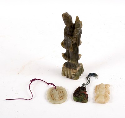 Lot 558 - A jade carving of a figure standing by a crane...