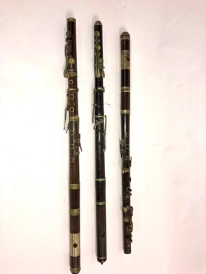 Lot 580 - A rosewood flute with another very similar and...